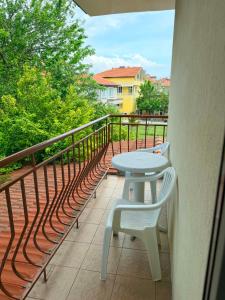 a balcony with a table and two chairs on it at Guest House Dayana Apartment 2 in Ravda