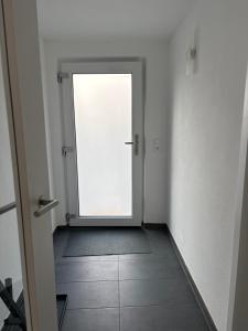 an empty hallway with a door in a room at VITA Apartment in Herrenberg