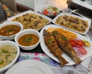 a table with plates of food and bowls of food at Sukoon Hideout Kaghan Valley in Lahar Bānda