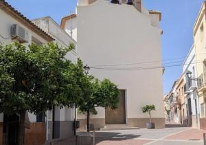a white building with trees on a street at Ca TONI in Daimuz
