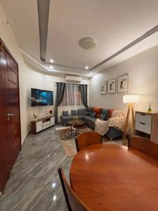 a living room with a couch and a table at La Cas'a Yehud in Aoudja