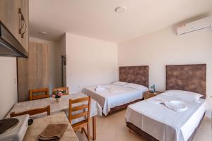 a hotel room with two beds and a table at Nefeli apartments in Borsh