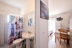 a white bathroom with a sink and a toilet at Nefeli apartments in Borsh