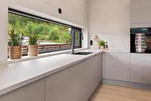 a kitchen with white cabinets and a window at Villa in Stryn in Stryn +32 photos