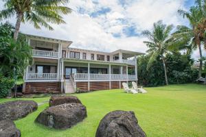 a large house with large rocks in the yard at Lei Ali'i in Haleiwa