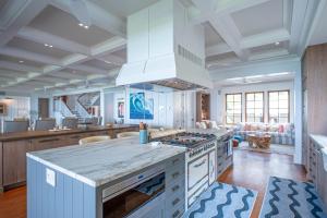 a large kitchen with a stove and a living room at Lei Ali'i in Haleiwa