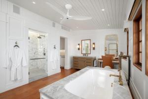 a white bathroom with a tub and a shower at Lei Ali'i in Haleiwa +73 photos