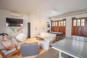 a living room with a ping pong table at Lei Ali'i in Haleiwa