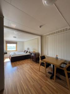 a bedroom with a bed and a desk and a table at 8 Seasons Hotel in Varangerbotn