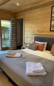 a bedroom with a large bed with towels on it at Chalet Isabelle Mountain lodge 5 stars 6 bedroom en suite sauna spa inox in Chamonix