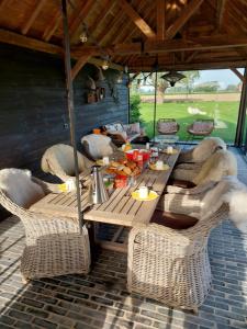 a group of tables with chairs and food on them at Vakantiewoning Maison Chaperon in Wervik