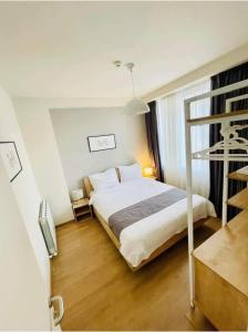 a bedroom with a white bed and a window at Hotel Archi Kokhta Bakuriani Apartment 305 in Bakuriani