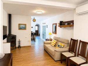 a living room with a couch and a stove at Casa Juana in Facinas