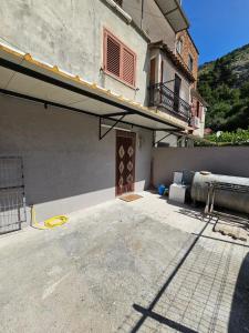 a building with a balcony and a building with a window at Daja's Guest House in Shëngjin