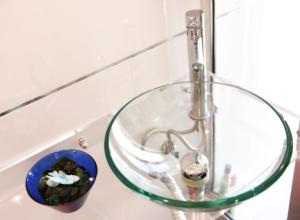 a glass bowl sitting on top of a bathroom sink at Appartamento Corso Italia 250 in Sorrento