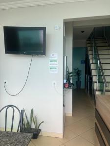 a flat screen tv on a wall in a hallway at Hotel Pará Santarém PA in Santarém +1 photo
