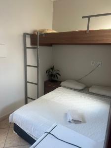 a bedroom with a bed and a bunk bed at Hotel Pará Santarém PA in Santarém