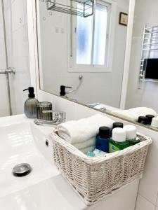 a bathroom with a basket on a sink at Casa Juana in Facinas +14 photos