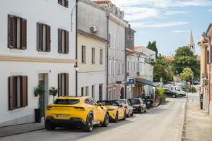 a yellow car parked on the side of a street at Heritage Hotel Ames in Poreč