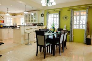 a dining room with a table and chairs in a kitchen at Cap Estate Ocean View Villa, Gros Islet, St Lucia in Dame de Traversay