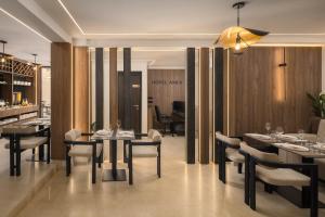 a restaurant with tables and chairs and a bar at Heritage Hotel Ames in Poreč