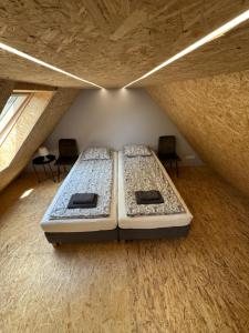 two beds in a room in a attic at Apartament Zbąszynek in Zbąszynek