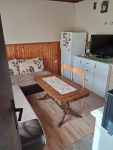 a small living room with a table and a couch at Srce Prirode in Pljevlja