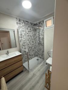 a bathroom with a shower and a sink and a toilet at La Barraca in Gandía +13 photos