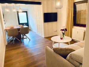 a living room with a couch and a table at Cosy Place Xanten in Xanten