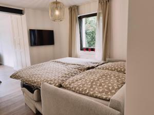 a bedroom with two beds and a window at Cosy Place Xanten in Xanten