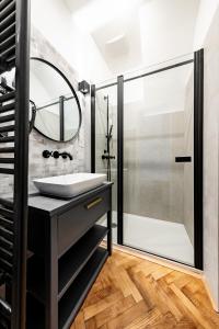 a bathroom with a sink and a shower at Main Square Apartments in Maribor
