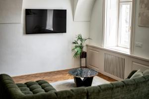 a living room with a couch and a table at Main Square Apartments in Maribor