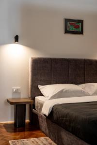 a bedroom with a bed and a side table at Main Square Apartments in Maribor