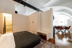 a bedroom with a bed and a desk in a room at Main Square Apartments in Maribor +64 photos