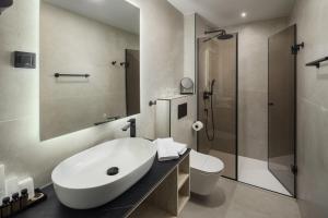 a bathroom with a sink and a toilet and a shower at Heritage Hotel Ames in Poreč +28 photos