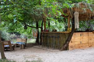 a bar in a tree with a table and chairs at Divlji Mir in Dobro Polje +32 photos