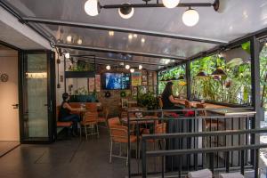 a restaurant with people sitting at tables at Hotel Living 35 Suites by Growing Group in Medellín