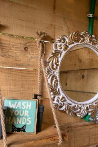 a mirror on a wall next to a sign at Divlji Mir in Dobro Polje