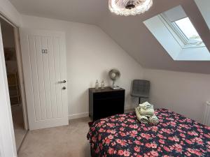a bedroom with a bed and a skylight at The Trinity - Double Room Suite 1 with Study and En-suite in High Wycombe