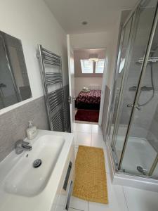 a bathroom with a sink and a shower and a tub at The Trinity - Double Room Suite 1 with Study and En-suite in High Wycombe