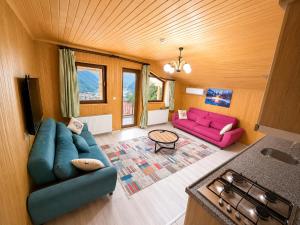 a living room with two couches and a table at Auga Apart in Uzungöl