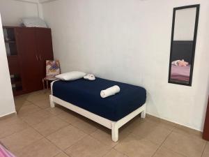 a bedroom with a bed with two pillows on it at Paraíso maya apartaments in Playa del Carmen +25 photos