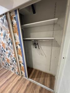 a walk in closet with a glass door at Studio au rdc cœur de ville 1 in Sélestat