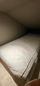 a white bed in a corner of a room at Lösen Retreat in Lyckeby