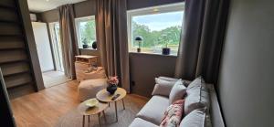 a living room with a couch and a window at Lösen Retreat in Lyckeby