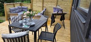 a patio with a table and chairs on a deck at Lösen Retreat in Lyckeby