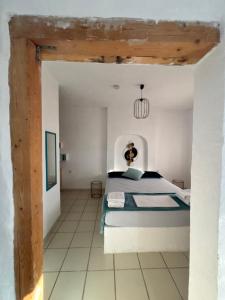 a bedroom with a bed in a white room at 7Olives Azure Boutique Apartment in Kastraki