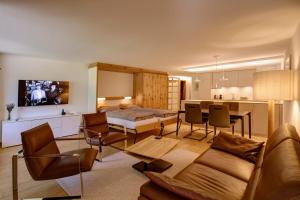 a living room with a couch and a table at Chesa Munteratsch 2-Zimmerwohnung 101 Typ E in Silvaplana