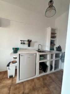 a white kitchen with a sink and a counter at 7Olives Azure Boutique Apartment in Kastraki