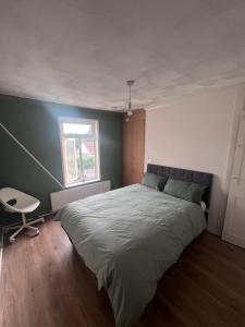 a bedroom with a large bed and a window at Gravesend Central - Spacious & Quiet Rooms in Gravesend +1 photo